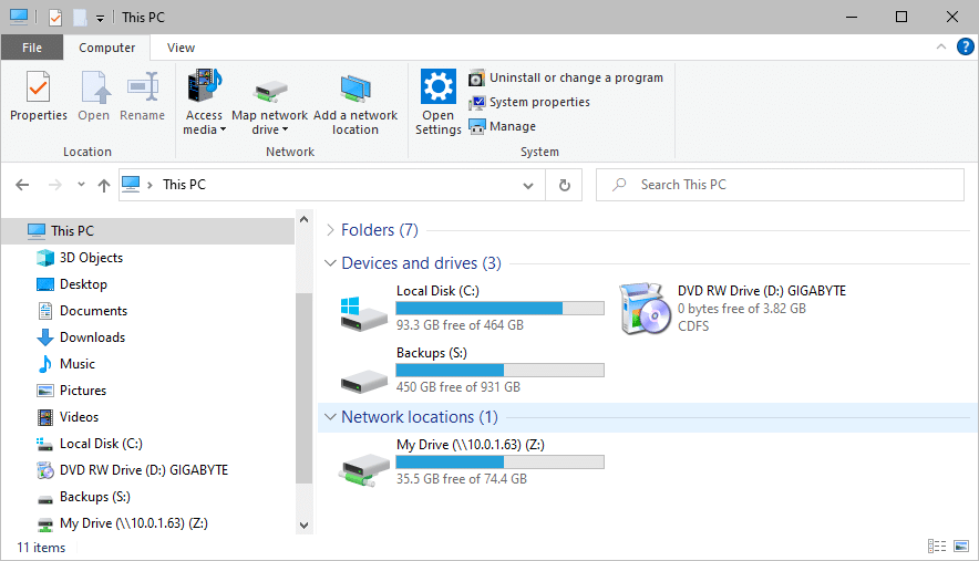 Windows File Explorer showing local disks, backup drives, and a mapped network drive under “This PC.”