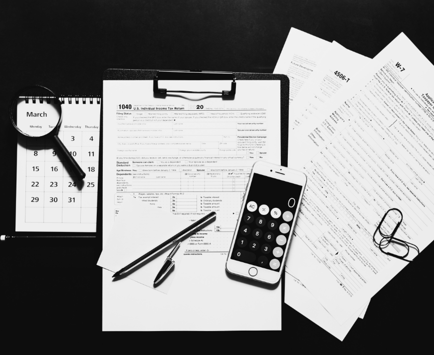 Compliance documentation with tax forms, calendar, and calculator symbolizing data governance